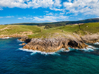 Aerial view of the coast with cliffs to the sea and cave in the rock. Cantabria.