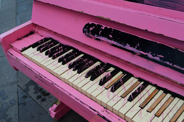 
Pink piano keys close-up in the city on the street.