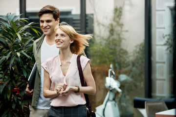 Fototapeta premium Happy female entrepreneur and her colleague walking together after work.