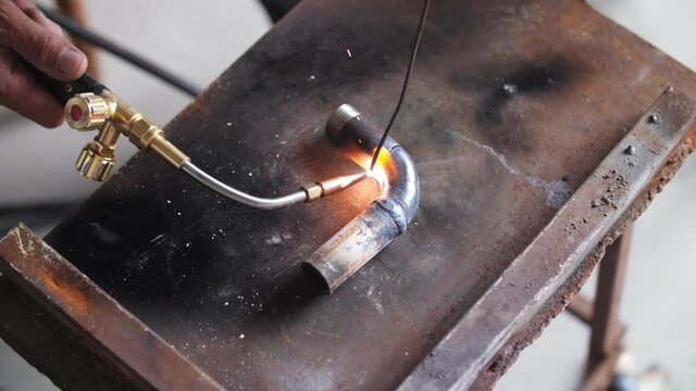 gas welding metal flying sparks close up