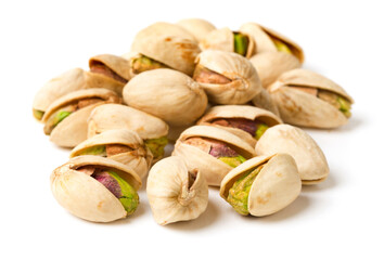 heap of roasted pistachios isolated on white background