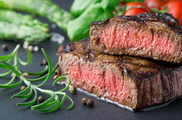 gilled cut steak on slate background