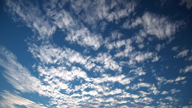 Cirrocumulus clouds in blue sky, time-lapse