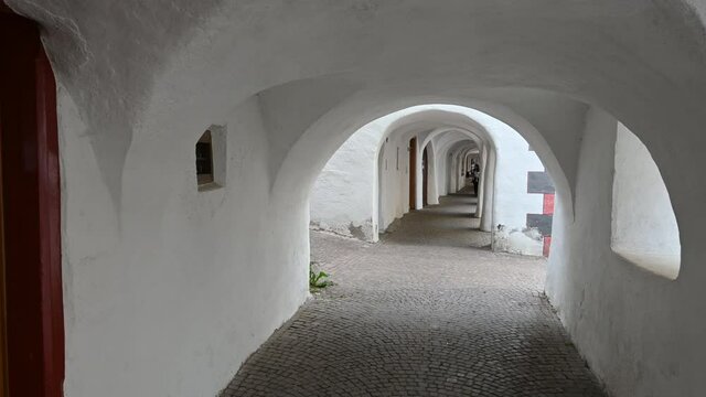 Glorenza, Trentino, Italy, June 2021. The characteristic whitewashed arcades of the pretty medieval village.