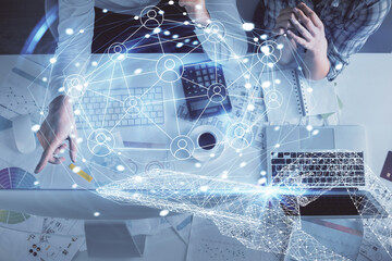 Double exposure of man and woman working together and social network theme hologram drawing. Computer background. connecting concept. Top View.