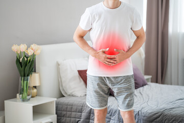 Man with abdominal pain suffering at home