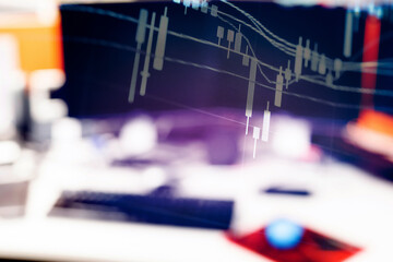 Abstract financial trading graphs and digital number of foreign exchange market trading on monitor. Background of gold and blue digital chart to represent stock market trend.	
