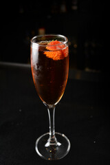 bartender special cold red wine cocktail or mocktail fruit juice with strawberry in tall glass goblet on black background luxury hotel pub iced beverage menu