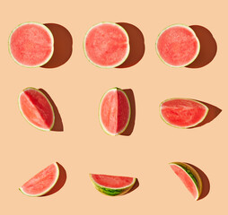 Cut watermelons on orange pastel background