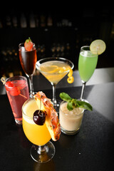 bartender make special cold cocktail or mocktail in tall glass goblet on black background luxury hotel pub iced beverage menu