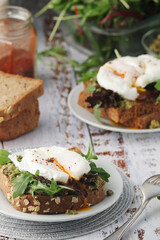 Homemade sandwiches with pesto, green salad and poached eggs