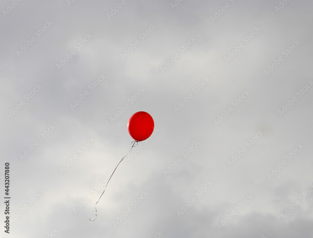 Wall mural balloon that has escaped to freedom soars in the stormy sky