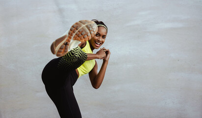 African sportswoman doing kick boxing exercise