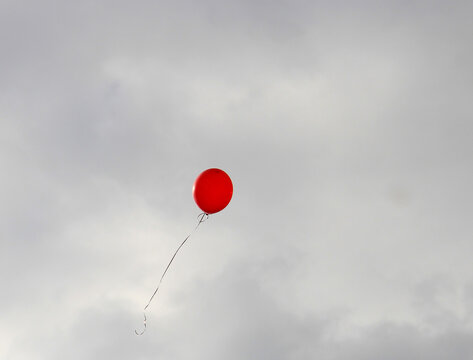 balloon that has escaped to freedom soars in the stormy sky