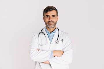 Handsome doctor smiling and standing on white background