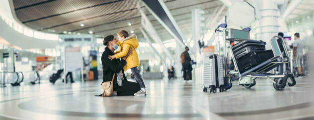 Happy mother and son meeting at airport after pandemic - obrazy, fototapety, plakaty