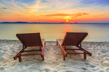 Lounge chairs sunset on the beach