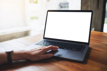 Mockup image of a woman using and touching on laptop touchpad with blank white desktop screen