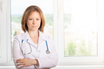 doctor or nurse stands at the medical clinic window, smiling,health and medicine