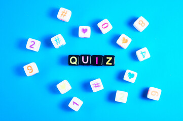 small black and white cubes with colored quiz writing