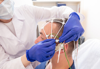 Patient brain testing using encephalography at medical center