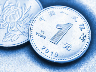 1 one Chinese yuan coins close-up. Blue tinted illustration about the economy, business, money and finance of PRC. National currency of China. Yuan of the new sample of 2019. Macro