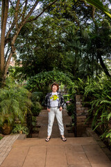 Fototapeta na wymiar woman tourist posing in tropical park 