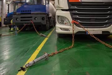 Preparing the handles and chains to the truck to start the safe journey in the hold of a ship.