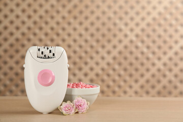 Set of epilation products on wooden table. Space for text