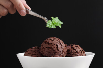 Food stylist use tweezers decorating fake icecream