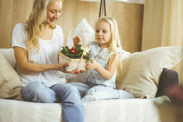 Happy mother day. Child daughter congratulates mom and gives her postcard with heart drawing. Family and childhood concepts