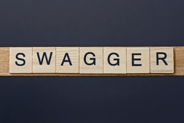 text on word swagger from gray wooden letters on a black background