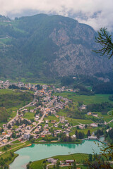 Aerial view of the little mountain town of Brusson with its nice lake in Ayas valley in Val D'Aosta, Italy