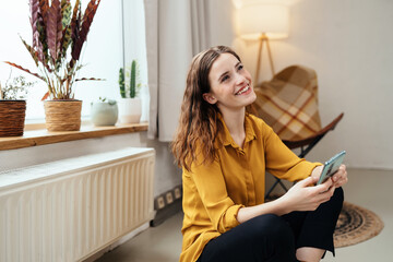 Cute young woman celbrating good news on her mobile