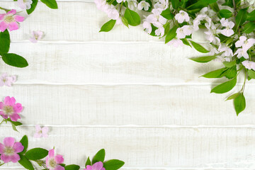  White and pink spring flowers on white wooden table, floral background