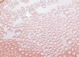 Water drops on pink background texture. backdrop glass covered with drops of water. bubbles in water