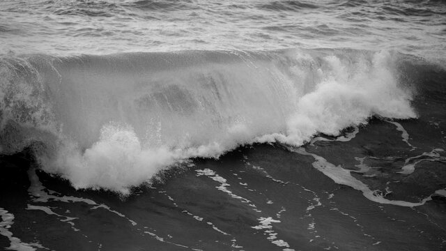 Beautiful dark dramatic toned fine art seascape image of breaking waves on Atlantic Ocean in Devon England