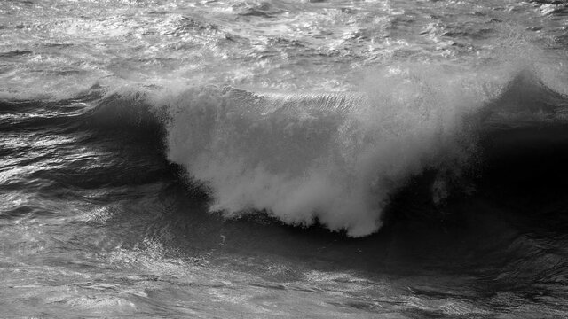 Beautiful dark dramatic toned fine art seascape image of breaking waves on Atlantic Ocean in Devon England