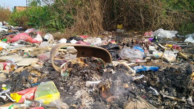 Garbage smoke burning on the side of the road