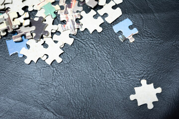 jigsaw puzzle on wooden background. to represent how complexity in game and challenge. plan and goal as concept.