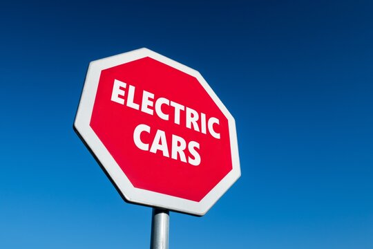 Stop sign with ELECTRIC CARS text to abandon controversial EVs as a future transportation