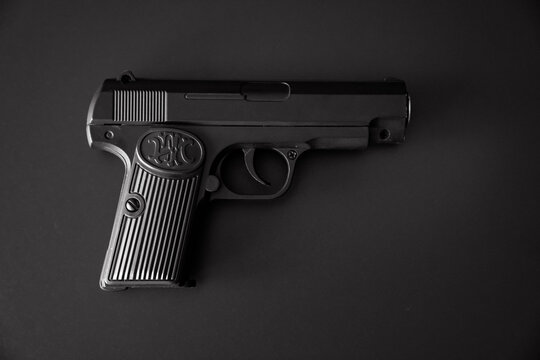 toy gun on a black background. dangerous toys.