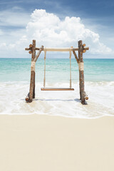 View of nice wooden swing on summer tropic beach