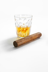 Closed up view of glass of whiskey with cigar on white back