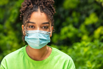 African American female young woman wearing face mask in Coronavirus COVID-19 pandemic - Powered by Adobe