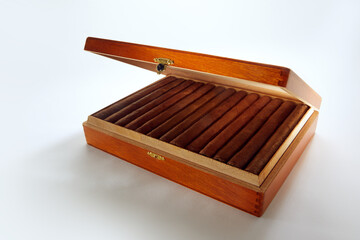 View of nice wooden humidor with cigars in it on white back