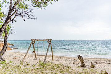 Nature in twilight period which including of sunrise over the sea and the nice beach. Summer beach with blue water and purple sky at the sunset.	
