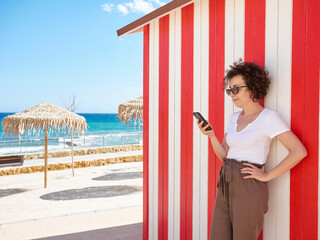 Woman looking at the phone during her summer vacation