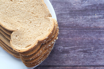 close up of stack of baked bread on table 