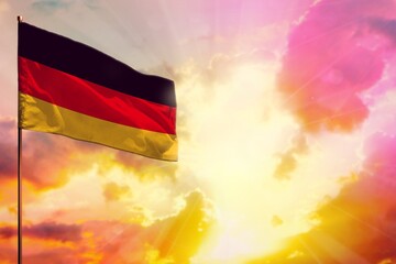 Fluttering Germany flag in top left corner mockup with the space for your text on beautiful colorful sunset or sunrise background.